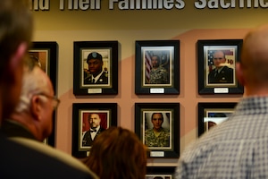 Gold Star Family members observe the Wall of Remembrance after an unveiling ceremony at Fort Eustis, Va., March 13, 2015. Gold Star Families are surviving relatives of fallen Service members. The wall depicts more than 50 Service members and their families who are a part of the Fort Eustis Survivor Outreach Services. (U.S. Air Force photo by Senior Airman Kimberly Nagle/Released)


