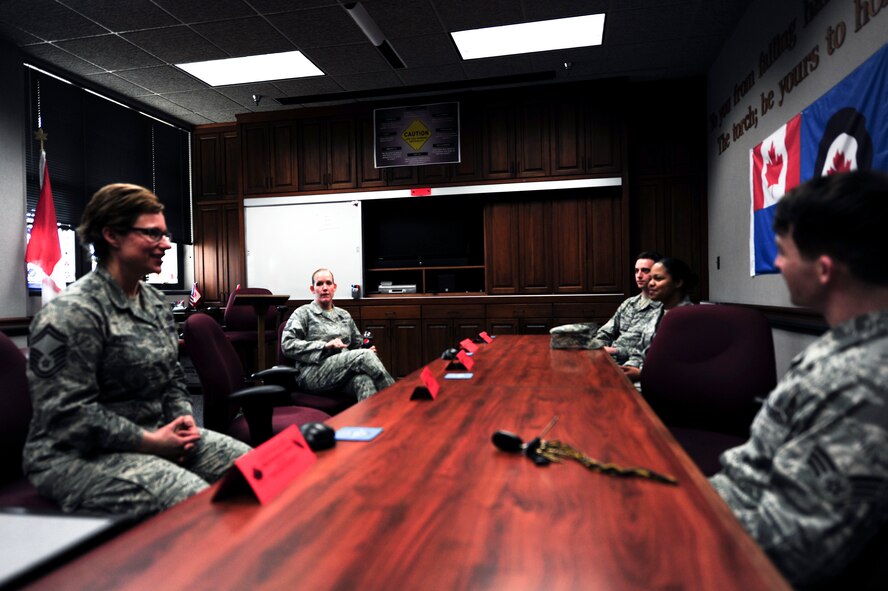 Senior Master Sgt. Hayden Pickett, Senior NCO Academy chief of programs and resources, and Master Sgt. Jennifer Johnson, Senior NCO Academy flight instructor, answer questions from junior enlisted Airmen who were on tour of the academy, March 12, 2015, Maxwell-Gunter Air Force Base, Alabama. During the day, junior enlisted Airmen toured the facility, watched a short mission video, received a briefing and attended a question-and-answer session with academy personnel. (U.S. Air Force photo by Airman 1st Class Alexa Culbert/Cleared)