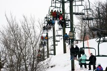 Airmen and their families from Minot Air Force Base, N.D., ride the ski lift during military appreciation day at Bottineau Winter Park, March 7, 2015. More than 170 Airmen and families were admitted into the park for free. (U.S. Air Force photo/Senior Airman Brittany Y. Bateman)