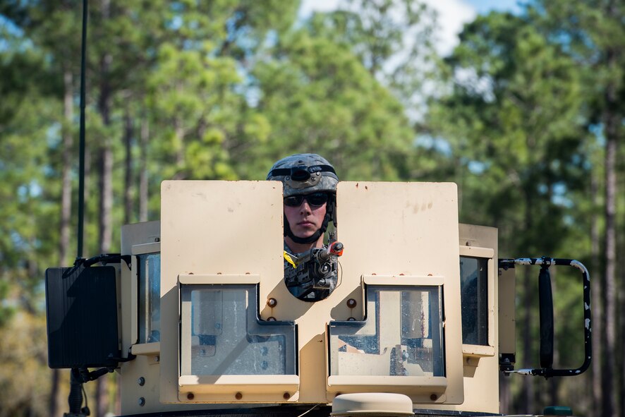 U.S. Air Force Airman 1st Class Bryan Bordelon Jr., 824th Base Defense Squadron fireteam member, scans his firing sector from a turret on top of a Humvee during a mission readiness exercise March 10, 2015, at Camp Blanding, Fla. Humvees serve as a bare-bones base’s main defense until defensive firing positions can be established. (U.S. Air Force Photo by Senior Airman Ryan Callaghan/Released)

