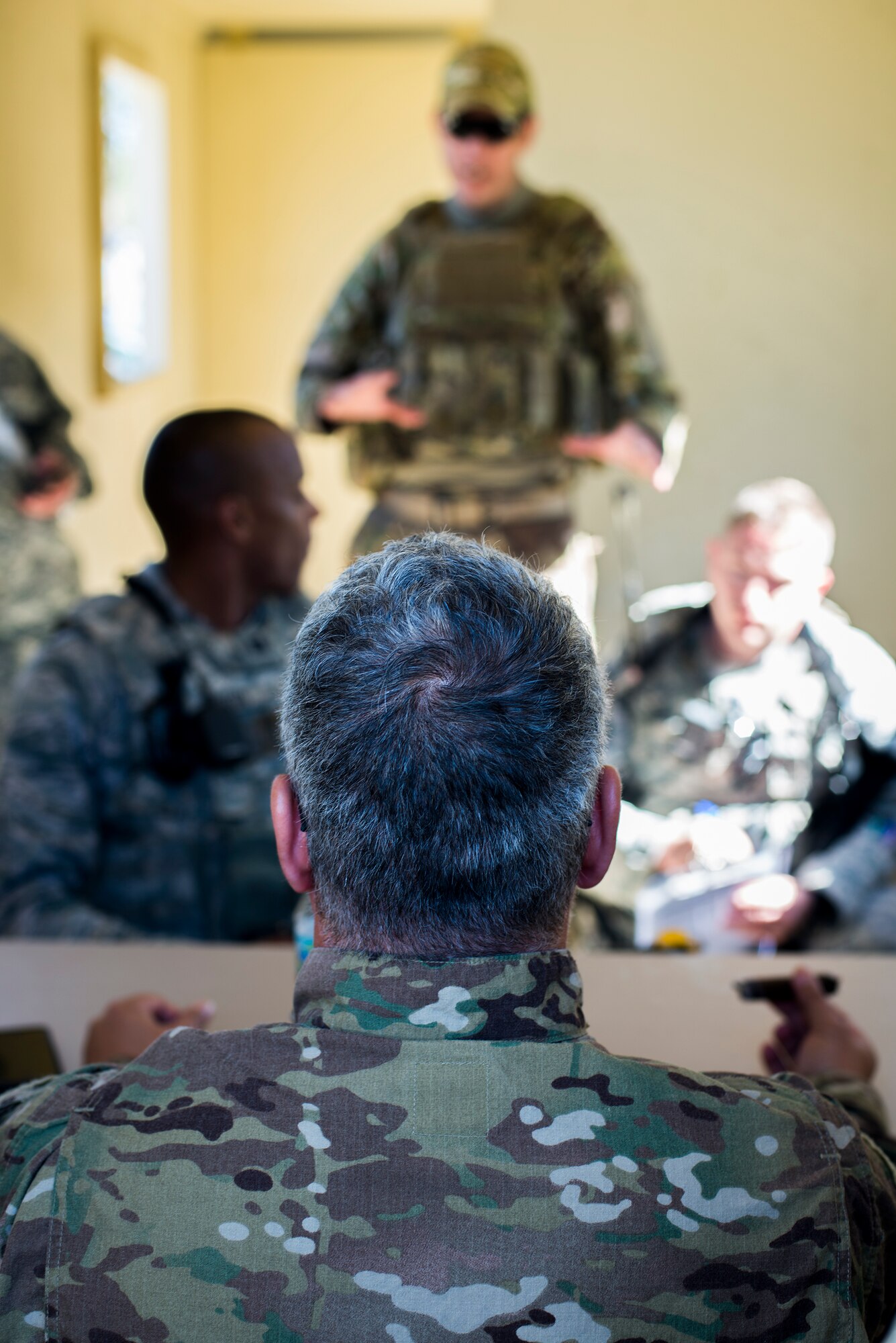 Members of the 824th Base Defense Squadron speak to host-nation role players after arriving to a bare-bones base for a mission readiness exercise March 10, 2015, at Camp Blanding, Fla. One of the squadron’s initial goals when arriving to a new location is establishing a good rapport with the host-nation forces and local natives. (U.S. Air Force Photo by Senior Airman Ryan Callaghan/Released)
