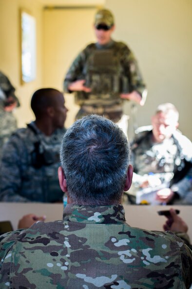 Members of the 824th Base Defense Squadron speak to host-nation role players after arriving to a bare-bones base for a mission readiness exercise March 10, 2015, at Camp Blanding, Fla. One of the squadron’s initial goals when arriving to a new location is establishing a good rapport with the host-nation forces and local natives. (U.S. Air Force Photo by Senior Airman Ryan Callaghan/Released)
