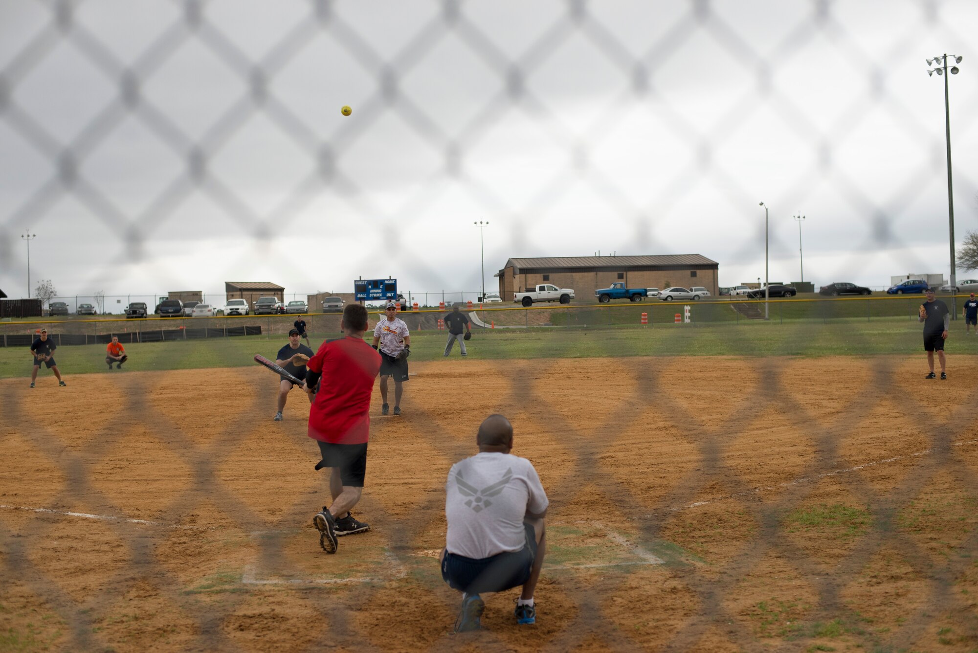 U.S. Air Force Col. Chad Franks, 23d Wing commander, hammers a softball between second and third base during the annual Eagles versus Chiefs softball game March 13, 2015, at Moody Air Force Base, Ga. Franks scored the first run in the game.  (U.S. Air Force photo by Staff Sgt. Eric Summers Jr./Released)