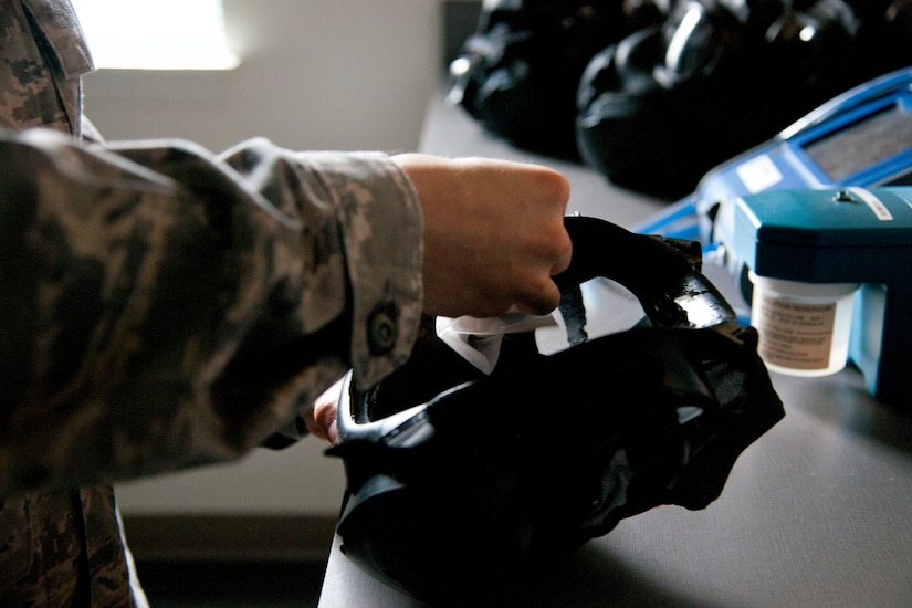 Senior Airman Thomas Hollingsworth, 779th Aerospace Medicine Squadron bioenvironmental technician, sanitizes a gas mask before a demonstration, March 16, 2015, on Joint Base Andrews, Md. The flight assists service members preparing for deployment by testing the fit of their gas masks, contributing to the safety of more than 1,400 service members per year. (U.S. Air Force photo/Senior Airman Mariah Haddenham)
