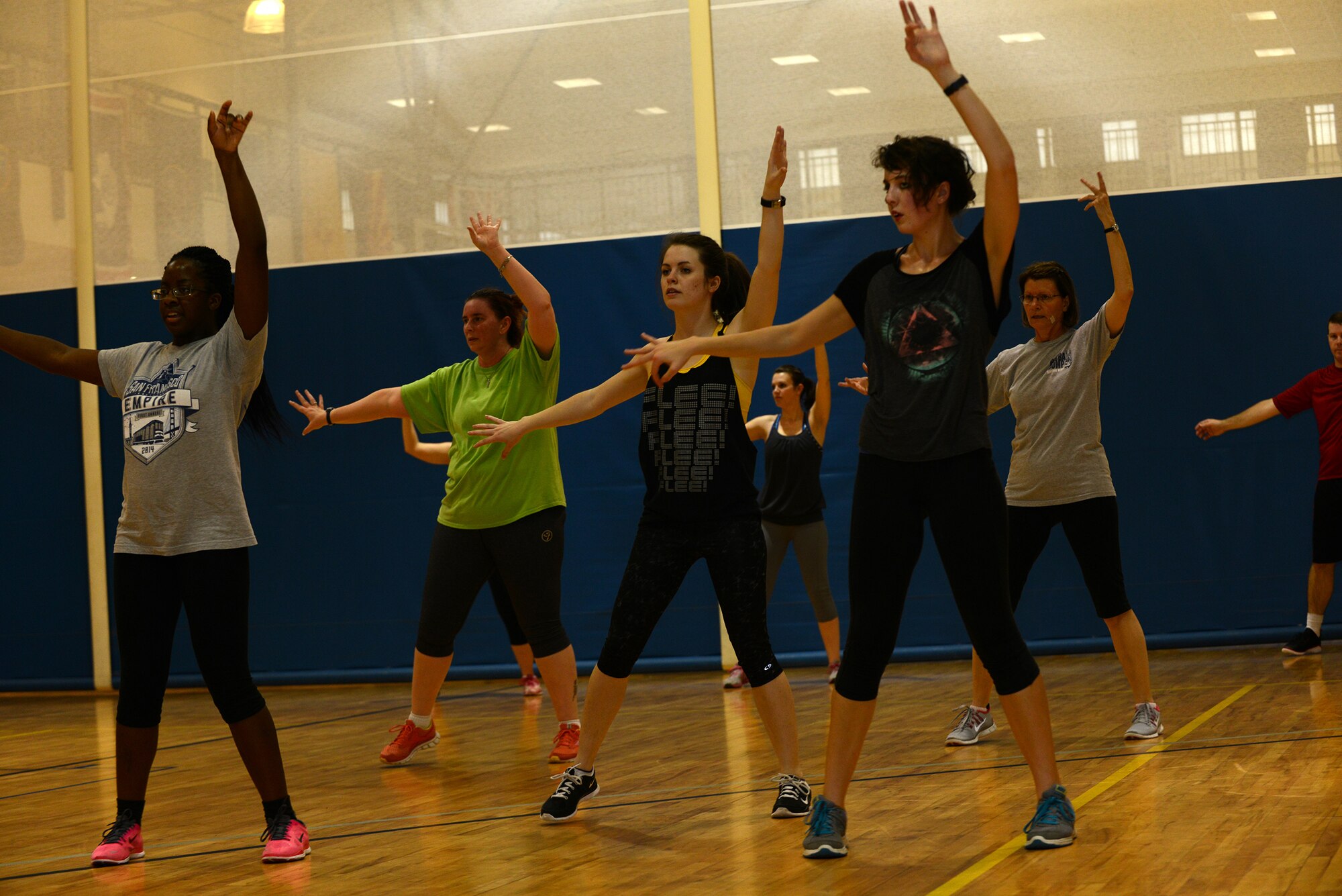 Team Moody members dance during the Zombie Zumba event March 13, 2015, at Moody Air Force Base, Ga. Zumba blends Latin and international rhythms to provide dance music for the workout. (U.S. Air Force photo by Airman 1st Class Kathleen D. Bryant/Released)