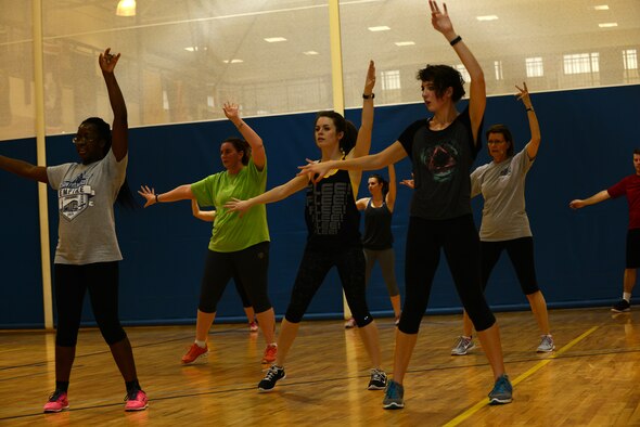 Team Moody members dance during the Zombie Zumba event March 13, 2015, at Moody Air Force Base, Ga. Zumba blends Latin and international rhythms to provide dance music for the workout. (U.S. Air Force photo by Airman 1st Class Kathleen D. Bryant/Released)
