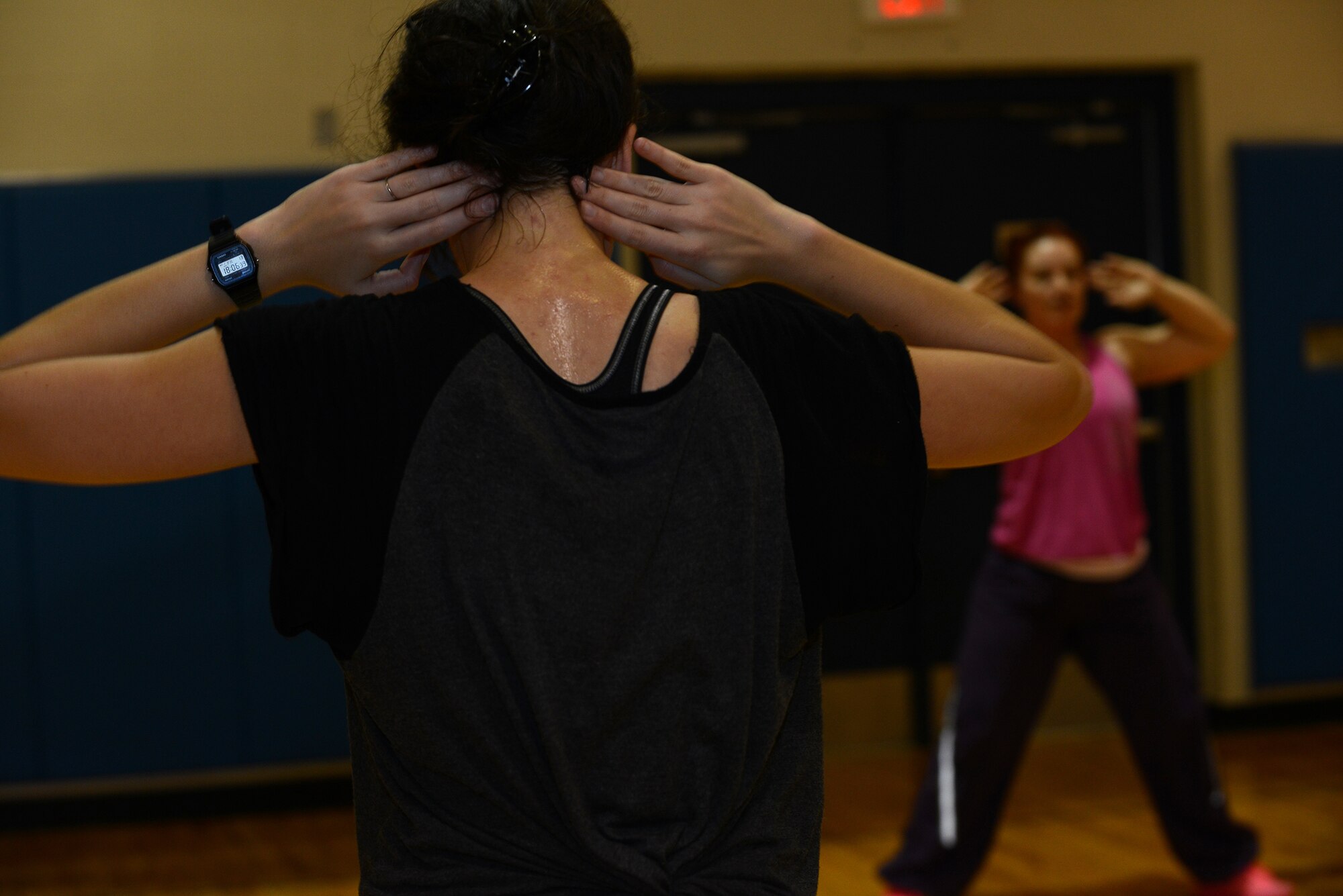 Esther Oswald, wife of U.S. Air Force Airman 1st Class Zachary Oswald, follows the lead of Katrina McReynolds, Zumba instructor, during the Zombie Zumba event March 13, 2015, at Moody Air Force Base, Ga. Participants combined fun and fitness during this event. (U.S. Air Force photo by Airman 1st Class Kathleen D. Bryant/Released)