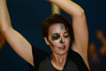 Esther Oswald, wife of U.S. Air Force Airman 1st Class Zachary Oswald, dances during the Zombie Zumba event March 13, 2015, at Moody Air Force Base, Ga. Oswald painted her face like a zombie for the event. (U.S. Air Force photo by Airman 1st Class Kathleen D. Bryant/Released)