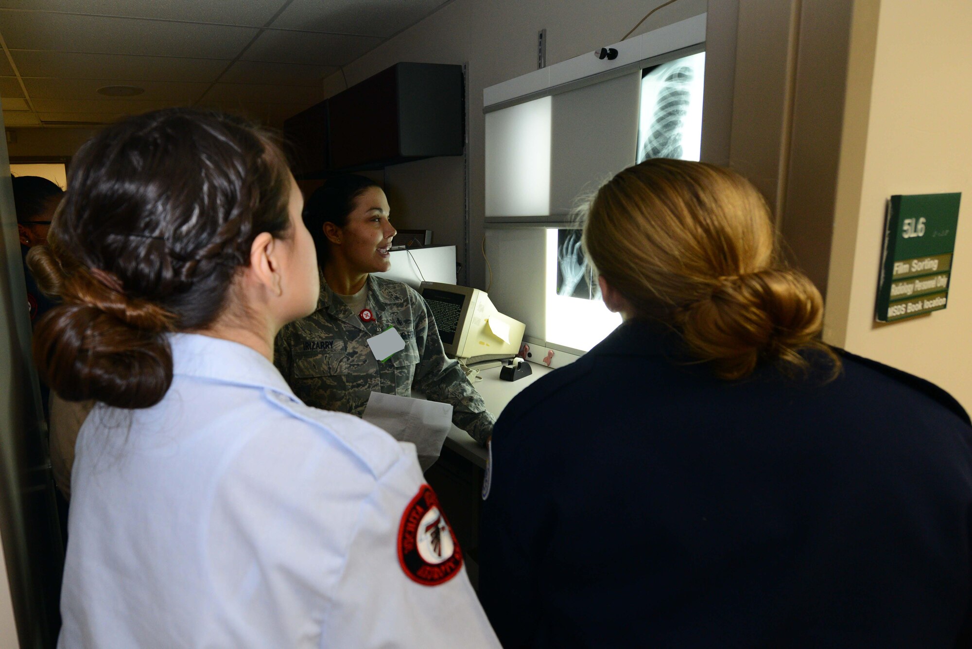 Tech. Sgt. Deanna Irizarry, 22nd Medical Support Squadron NCO in charge of diagnostic imaging, shows Junior ROTC cadets X-ray films, March 11, 2015, at McConnell Air Force Base, Kan. Cadets from local schools visited the 22nd MSS to learn about how different career fields are needed to complete the Air Force mission. (U.S. Air Force photo by Airman 1st Class Christopher Thornbury)