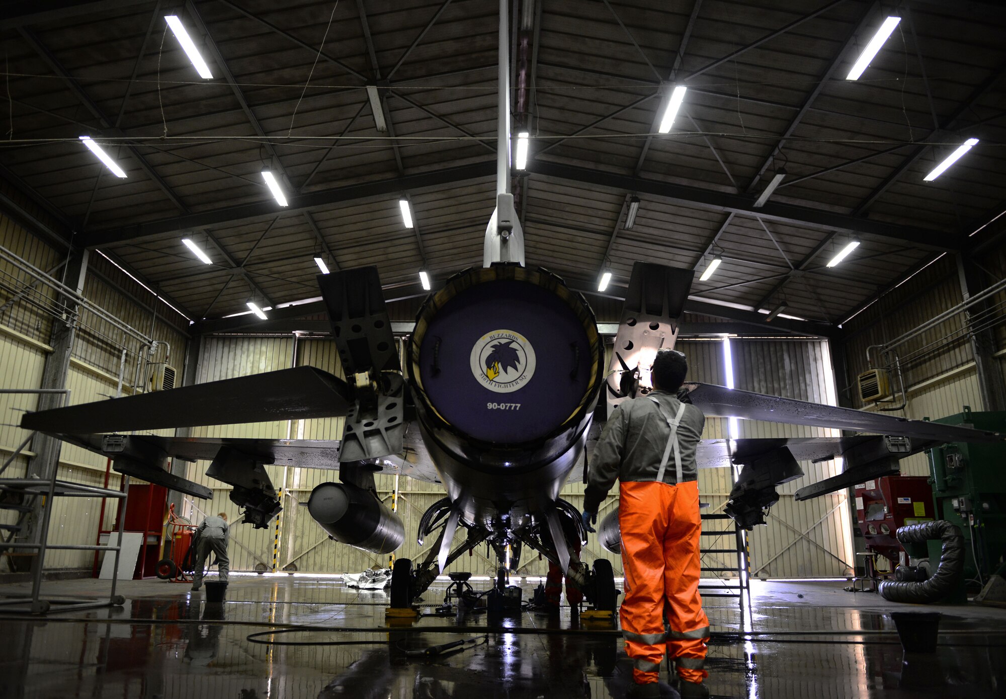 U.S. Air Force Staff Sgt. Michael John Maxwell, 31st Aircraft Maintenance Squadron dedicated crew chief, inspects an F-16 Fighting Falcon after washing the aircraft, March 17, 2015, at Aviano Air Base, Italy. Crew chiefs are responsible for washing Aviano’s F-16s to help protect the aircraft from corrosion. (U.S. Air Force photo by Senior Airman Matthew Lotz/Released)