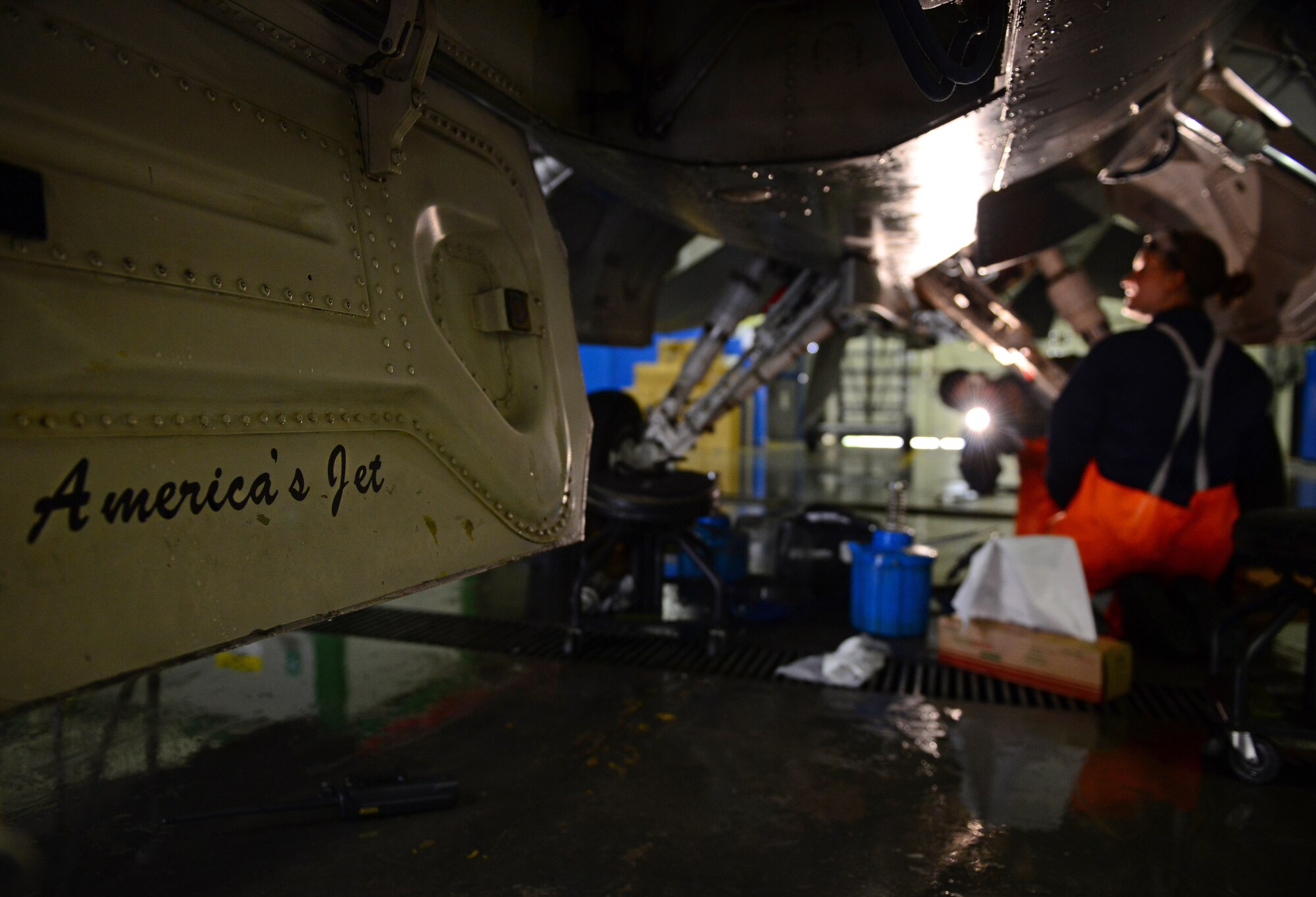 U.S. Air Force crew chiefs from the 31st Aircraft Maintenance Squadron inspect landing gear on an F-16 Fighting Falcon after washing the aircraft, March 17, 2015, at Aviano Air Base, Italy. Crew chiefs are responsible for washing Aviano’s F-16s to help protect the aircraft from corrosion. (U.S. Air Force photo by Senior Airman Matthew Lotz/Released)