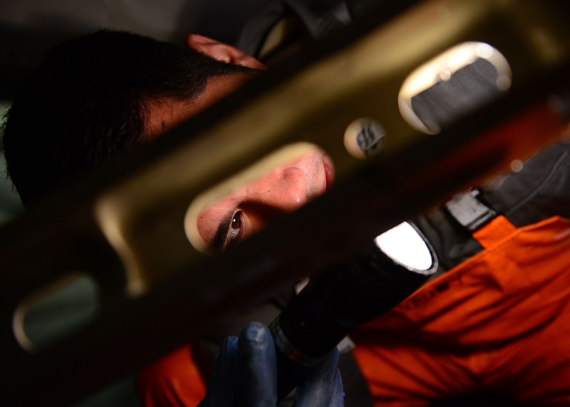 U.S. Air Force Staff Sgt. Michael John Maxwell, 31st Aircraft Maintenance Squadron dedicated crew chief, inspects landing gear on an F-16 Fighting Falcon after washing the aircraft, March 17, 2015, at Aviano Air Base, Italy. Washing an aircraft takes approximately 4 to 6 hours for a minimum of three crew chiefs. (U.S. Air Force photo by Senior Airman Matthew Lotz/Released)