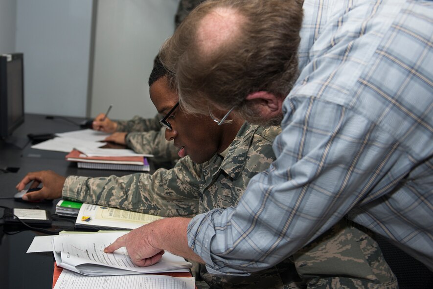 U.S. Air Force Airman Treyton-Thomas Juopperi, 364th Training Squadron student, receives instructions for an assignment at Sheppard Air Force Base, Texas, March 16, 2015. Harold Green, 364th TRS instructor, taught him about aircraft electrical and environmental systems. (U.S. Air Force photo by Senior Airman Kyle Gese)