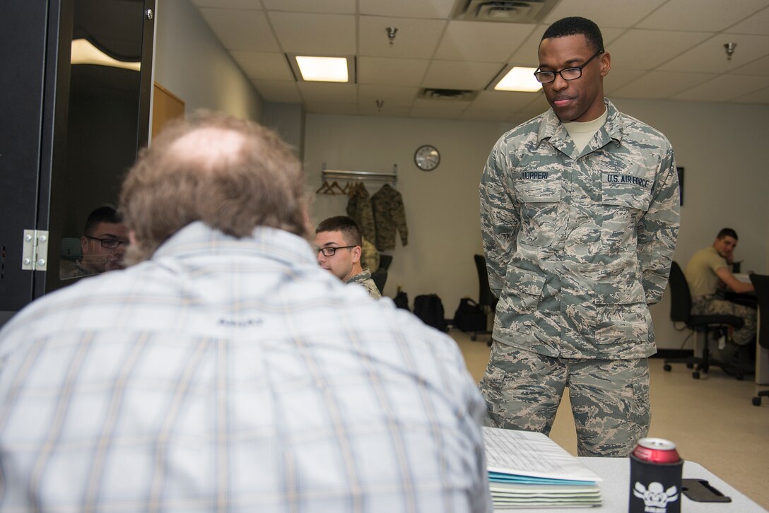 U.S. Air Force Airman Treyton-Thomas Juopperi, 364th Training Squadron student, stands in front of his instructor’s desk at Sheppard Air Force Base, Texas, March 16, 2015. Juopperi’s mother served three tours in Iraq but passed away during her last tour from an improvised explosive device. His mother’s sacrifice inspired his decision to join the U.S. Air Force. (U.S. Air Force photo by Senior Airman Kyle Gese)