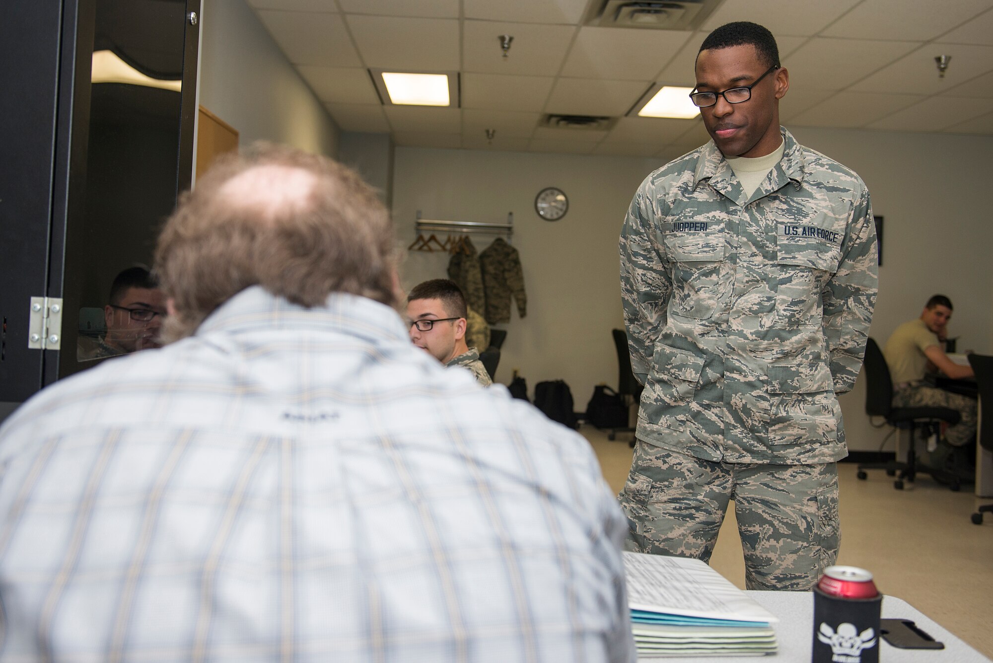 U.S. Air Force Airman Treyton-Thomas Juopperi, 364th Training Squadron student, stands in front of his instructor’s desk at Sheppard Air Force Base, Texas, March 16, 2015. Juopperi’s mother served three tours in Iraq but passed away during her last tour from an improvised explosive device. His mother’s sacrifice inspired his decision to join the U.S. Air Force. (U.S. Air Force photo by Senior Airman Kyle Gese)