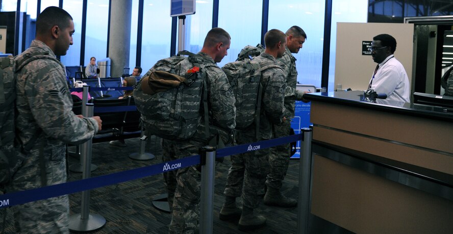 927th Security Forces Squadron members head through the gate at Tampa international Airport, Sunday March 15. This is the first leg of a trip that will ultimately take them to an undisclosed location in Southwest Asia.  For the first time since 9/11 the 927 SFS is deploying as a squadron. More than 80 percent of the squadron has or will ship out within the next week or so. (U.S. Air Force photo/Tech Sgt. Peter Dean)