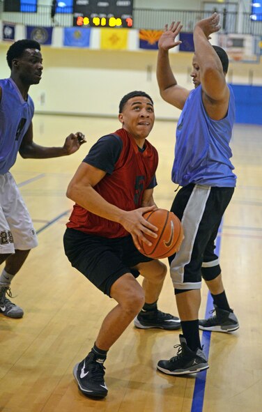 U.S. Air Force Senior Airman Stetson Grange, 100th Logistics Readiness Squadron unit deployment manager from Middleburg, Fla., goes for a layup during the basketball championship game March 12, 2015, at the Hardstand Fitness Center on RAF Mildenhall, England. The 100th Civil Engineer Squadron won against 100th LRS 67-53. (U.S. Air Force photo by Senior Airman Christine Griffiths/Released)