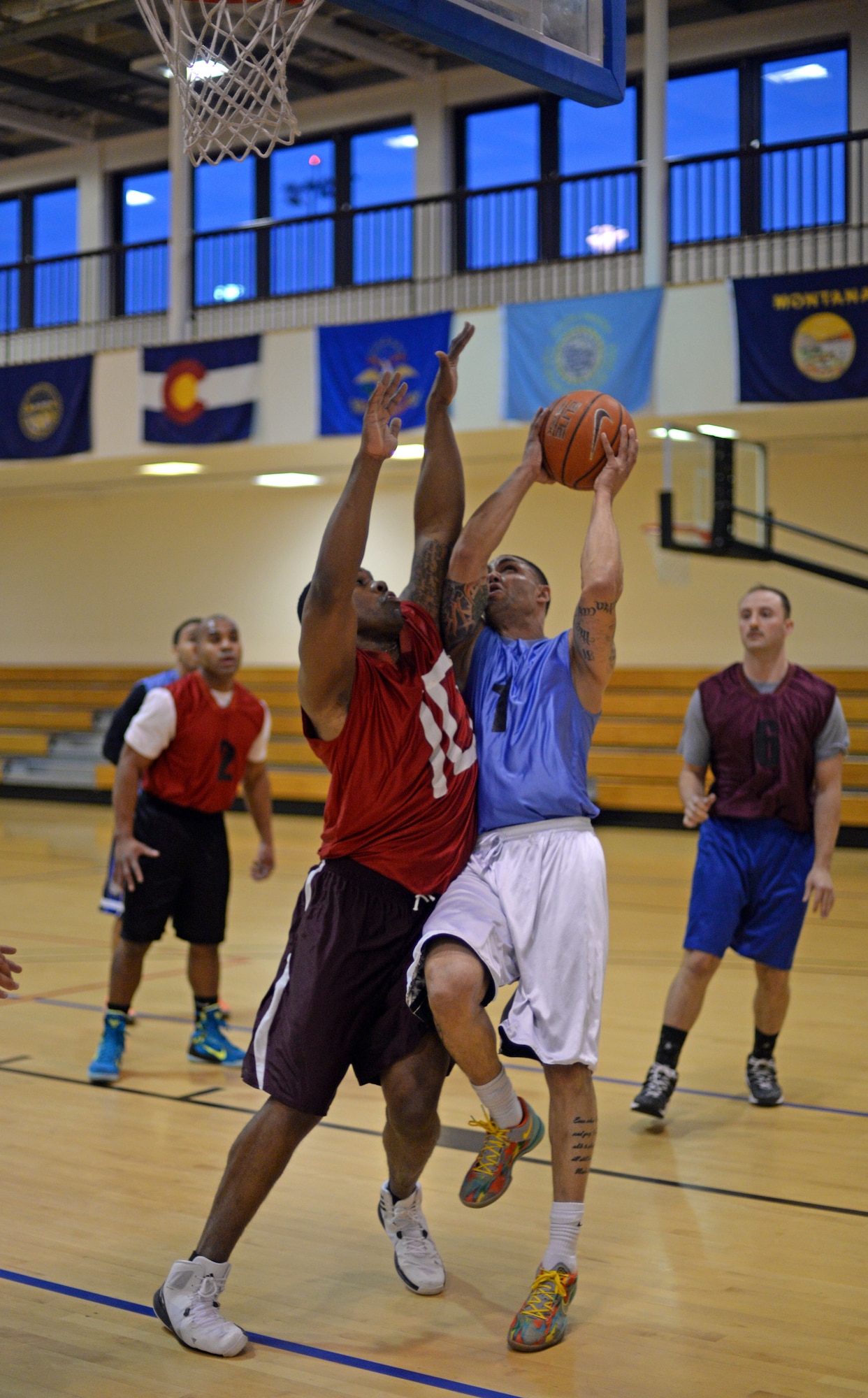 U.S. Air Force Staff Sgt. Timothy White, right, 100th Civil Engineer Squadron NCO in charge of service contracts from Sierra Vista, Ariz., goes for a layup as U.S. Air Force Staff Sgt. Steven McCoy, 100th Logistics Readiness Squadron NCO in charge of inbound receiving from Columbia, Ohio, blocks him during a basketball championship game March 12, 2015, at the Hardstand Fitness Center on RAF Mildenhall, England. The 100th CES stands champion to the 100th LRS with a final score of 67-53. (U.S. Air Force photo by Senior Airman Christine Griffiths/Released)