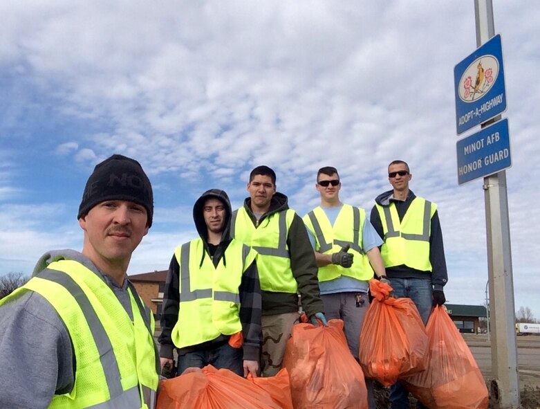 Members from the Minot Air Force Base Honor Guard clean their highway in Minot, N.D., March 12, 2015. Units from the base embraced the “adopt-a-highway” initiative to keep the community clean from debris. (U.S. Air Force photo/Staff Sgt. Joshua Hull) 