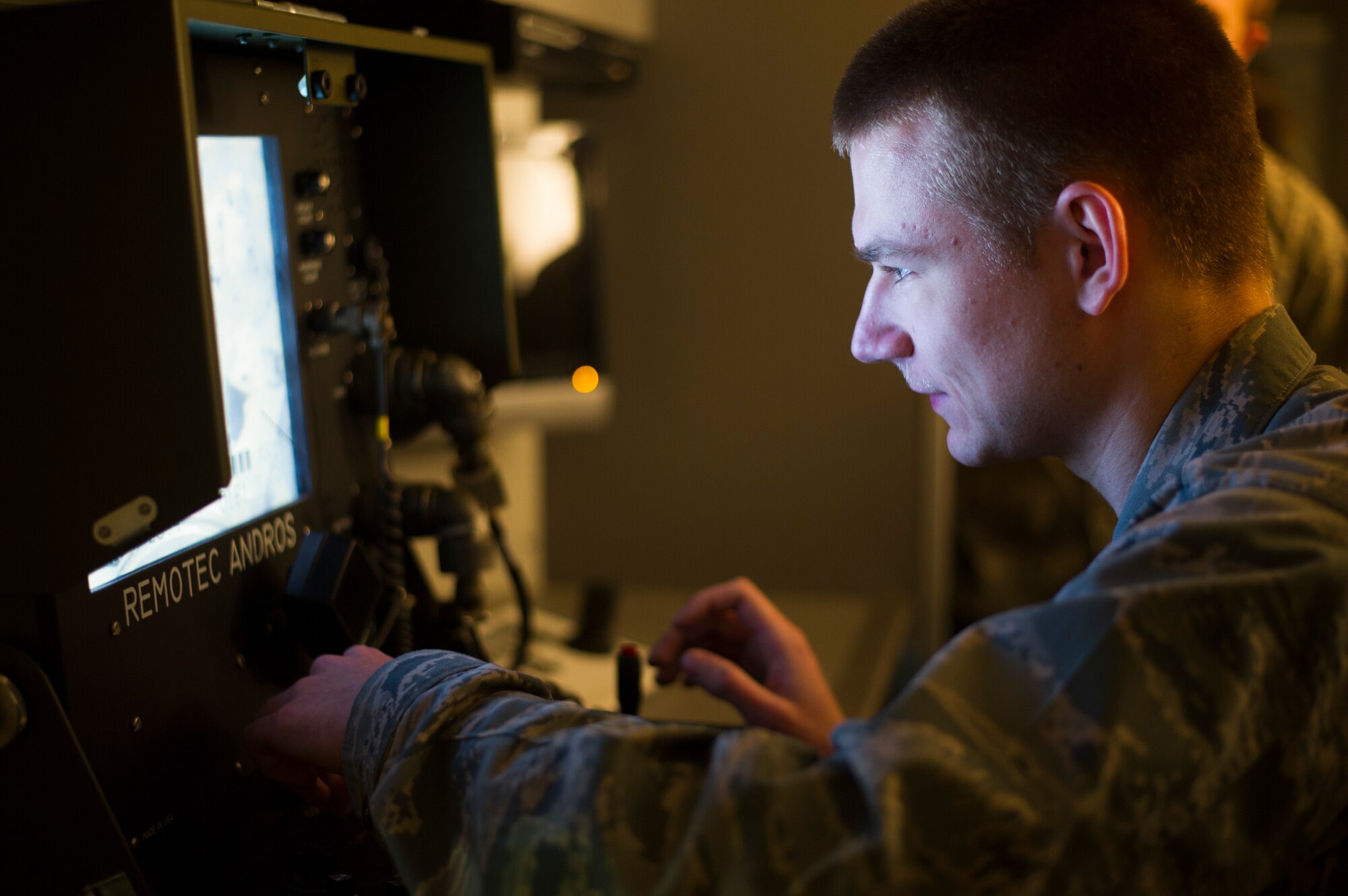 Cadet Alexander Gottzmann controls a robot during a Reserve Officers' Training Corps tour at the 11th Civil Engineer Squadron explosive ordnance disposal facility at Joint Base Andrews, Md., March 16, 2015. Robotics allow EOD technicians to safely and efficiently dispose of munitions that were once too dangerous or inaccessible. (U.S. Air Force photo/Staff Sgt. Chad C. Strohmeyer/Released)