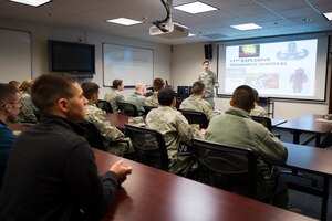 Senior Airman Richard Mirabal, 11th Civil Engineer Squadron explosive ordnance disposal technician, briefs several Reserve Officers' Training Corps cadets during a tour at Joint Base Andrews, Md., March 16, 2015. The tour is held several times a month and is designed to immerse cadets in their respective career fields prior to active service. (U.S. Air Force photo/Staff Sgt. Chad C. Strohmeyer/Released)