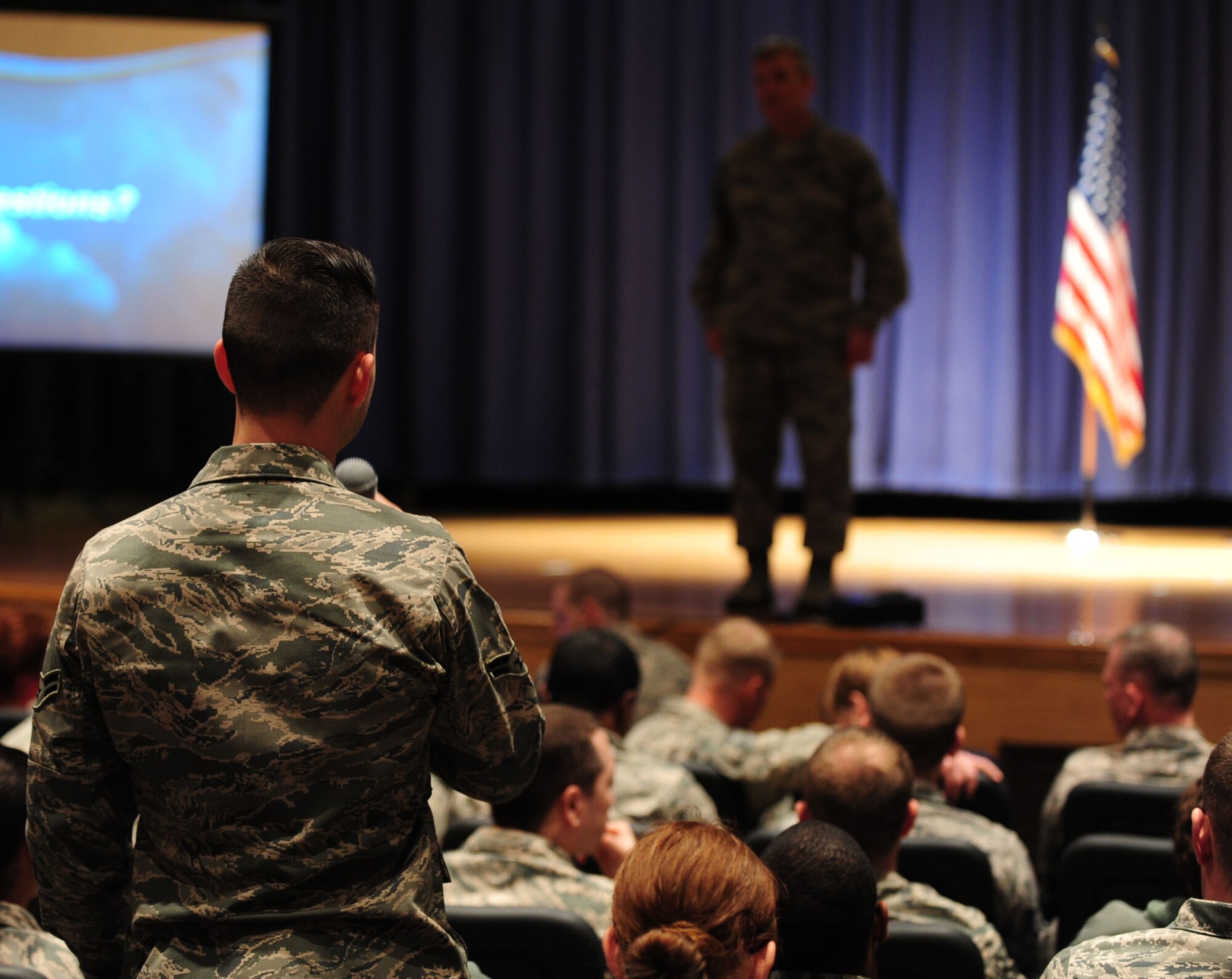 U.S. Air Force Gen. Hawk Carlisle, commander of Air Combat Command, answers Airmen’s questions during a commander’s call at Langley Air Force Base, Va., March 13, 2015. Carlisle addressed issues such as budget, force management, deployments and Comprehensive Airmen Fitness.  (U.S. Air Force photo by Staff Sgt. Natasha Stannard/Released)
