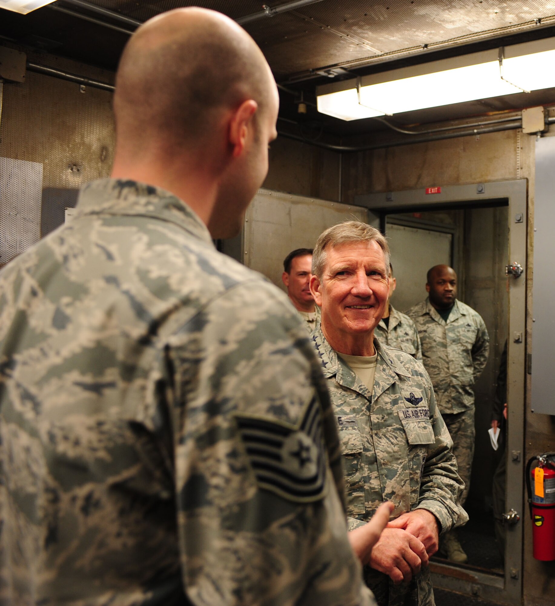 U.S. Air Force Gen. Hawk Carlisle, commander of Air Combat Command, listens as Tech Sgt. Arik Wexler, 1st Component Maintenance Squadron, speaks about maintenance operations at Langley Air Force Base, Va., March 13, 2015. Carlisle visited various units that enable Joint Base Langley-Eustis to provide mission-ready warfighters to support global military operations. (U.S. Air Force photo by Staff Sgt. Natasha Stannard/Released) 