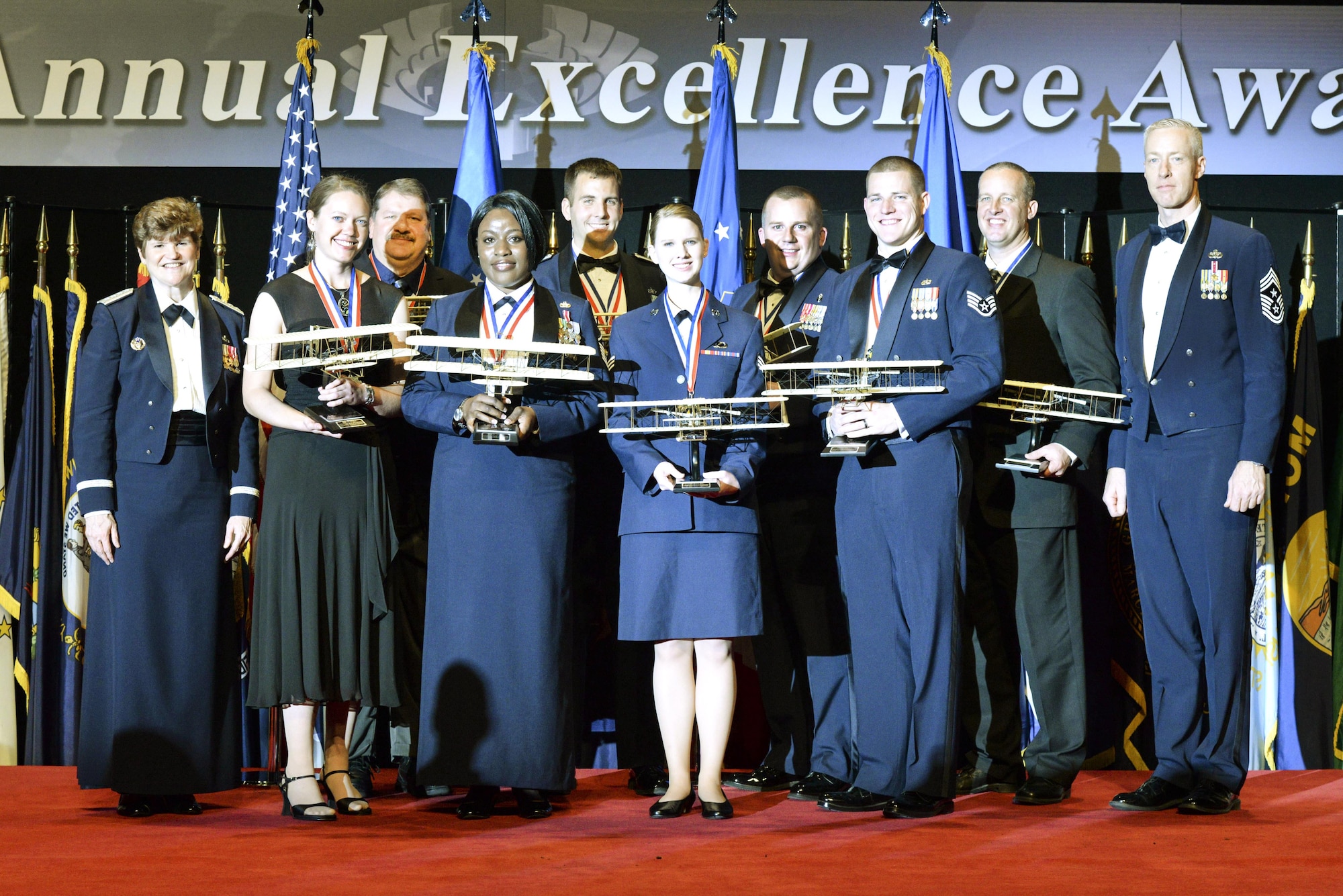Air Force Materiel Command's Annual Excellence Award winners for 2014 stand on stage at the ceremony. From left: Gen. Janet Wolfenbarger, AFMC commander; Laura Letterman, Hollomon Air Force Base, New Mexico; Theron Jones, Robins AFB, Georgia; Master Sgt. Freda Dey, Eglin AFB, Florida; Capt. Benjamin Carlson, Tyndall AFB, Florida; Senior Airman Natalie Norlock, Joint Base San Antonio, Texas; Master Sgt. Raymond Hillis, Wright-Patterson AFB, Ohio; Staff Sgt. Kurtis Harrison, Eglin AFB; Travis Adams, Hill AFB, Utah; and Chief Master Sgt. Michael Warner, AFMC command chief. (U.S. Air Force photo/Wesley Farnsworth)