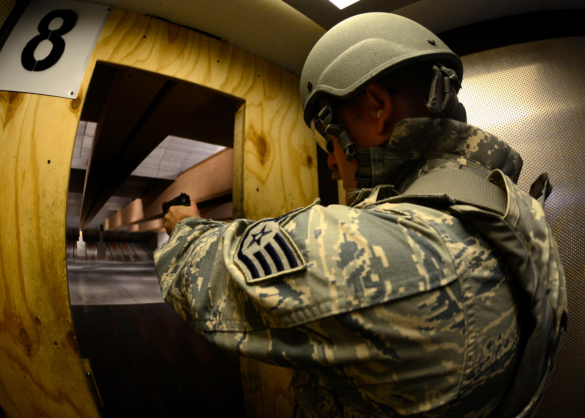U.S. Air Force Staff Sgt. Buckley Osteen, 31st Fighter Wing command post emergency actions controller, fires the M9 Beretta pistol, March 16, 2014 at the firing range at Aviano Air Base, Italy. Students also attended a classroom portion, where they learned reloading, assembly and cleaning procedures. (U.S. Air Force photo by Senior Airman Areca T. Wilson/Released)