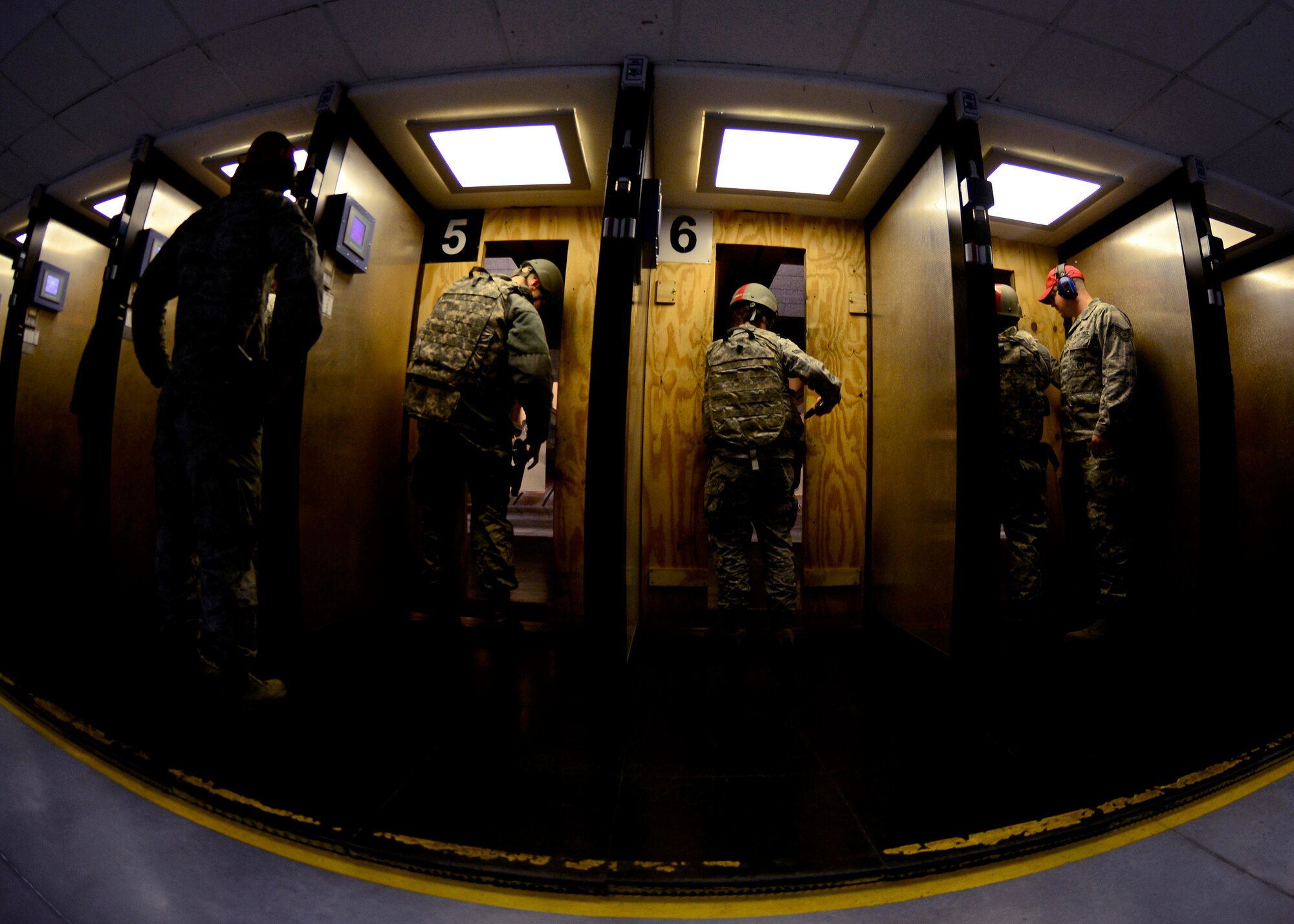 U.S. Air Force Airmen prepare to fire the M9 Beretta pistol, March 16, 2014 at the firing range at Aviano Air Base, Italy. During combat arms training drills, students fire at targets using various positions such as kneeling and standing. (U.S. Air Force photo by Senior Airman Areca T. Wilson/Released)