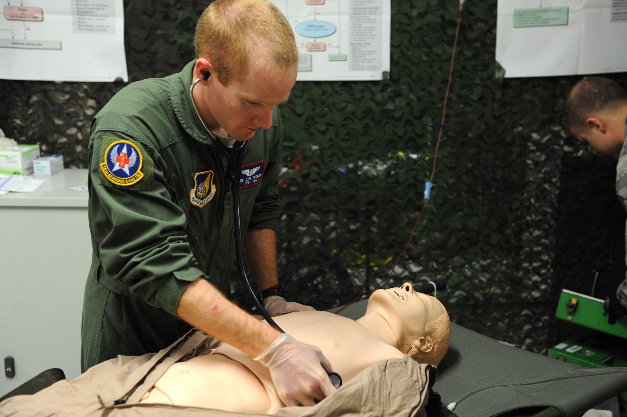 U.S. Air Force Staff Sgt. Joel Pallon, 18th Aeromedical Evacuation Squadron air evacuation medic, listens to the sounds of a collapsed lung during training on Kadena Air Base, Japan, March 4, 2015. Training on different aspects of medical emergencies helps prepare team members for whatever situation may arise. (U.S. Air Force photo by Airman 1st Class Stephen G. Eigel)