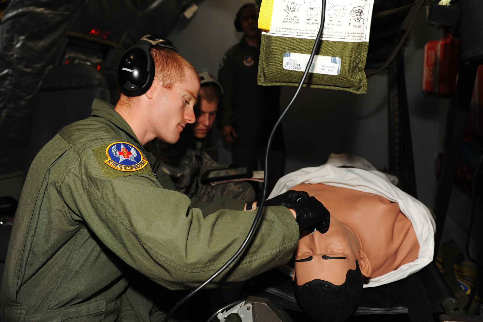 U.S. Air Force Staff Sgt. Joel Pallon, 18th Aeromedical Evacuation Squadron air evacuation medic, goes through a possible inflight scenario during training on Kadena Air Base, Japan, March 4, 2015. Practicing scenarios helps keep the medics calm when they are put in a real life crisis. (U.S. Air Force photo by Airman 1st Class Stephen G. Eigel)