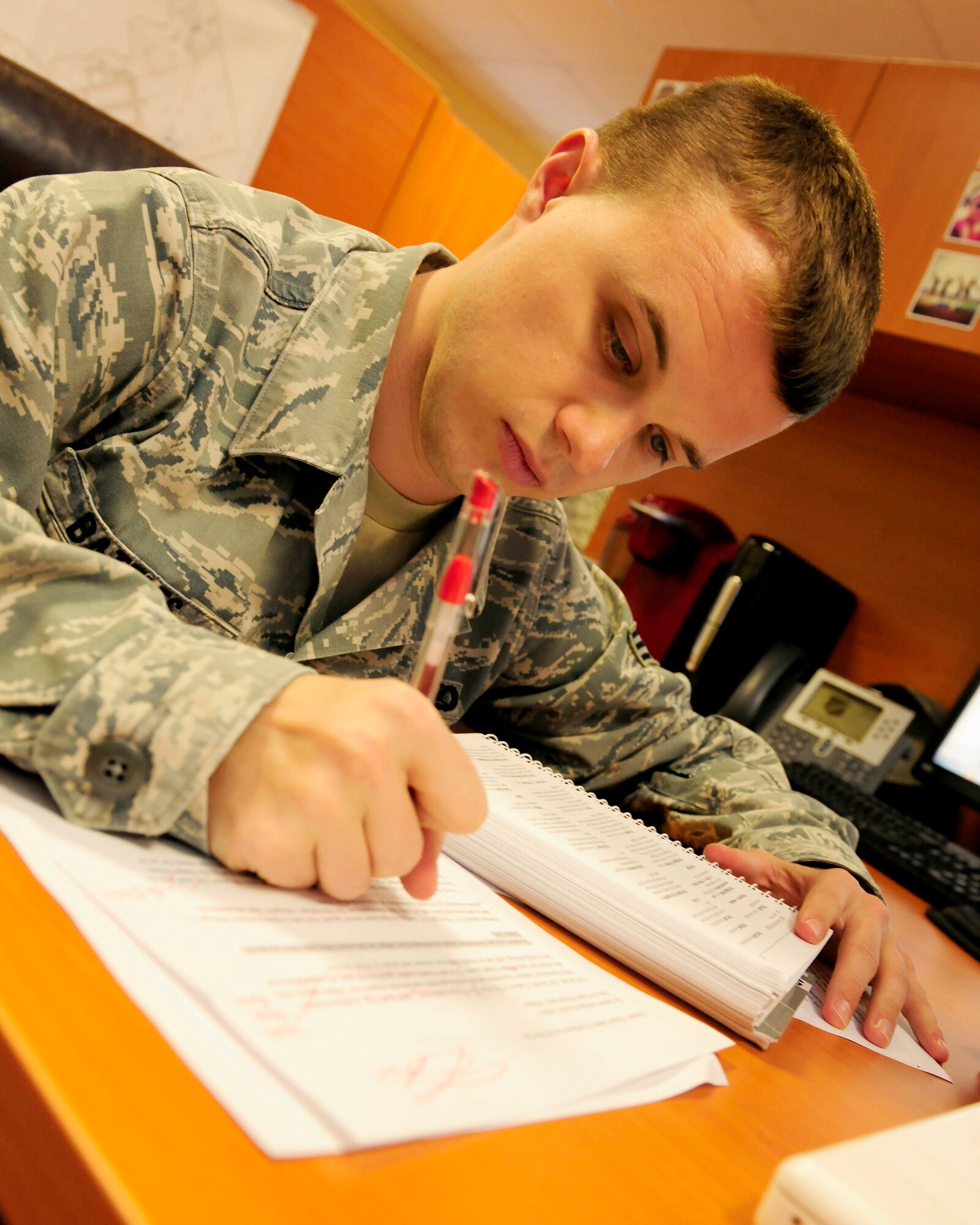 Senior Airman Michael Battles, 39th Air Base Wing Public Affairs photojournalist journeyman, edits an article March 5, 2015, at Incirlik Air Base, Turkey. The 39th ABW Public Affairs office won multiple awards in the U. S. Air Forces in Europe – U.S. Air Forces in Africa Media Contest and Communication Excellence Awards. (U.S. Air Force photo by Senior Airman Krystal Ardrey/Released)