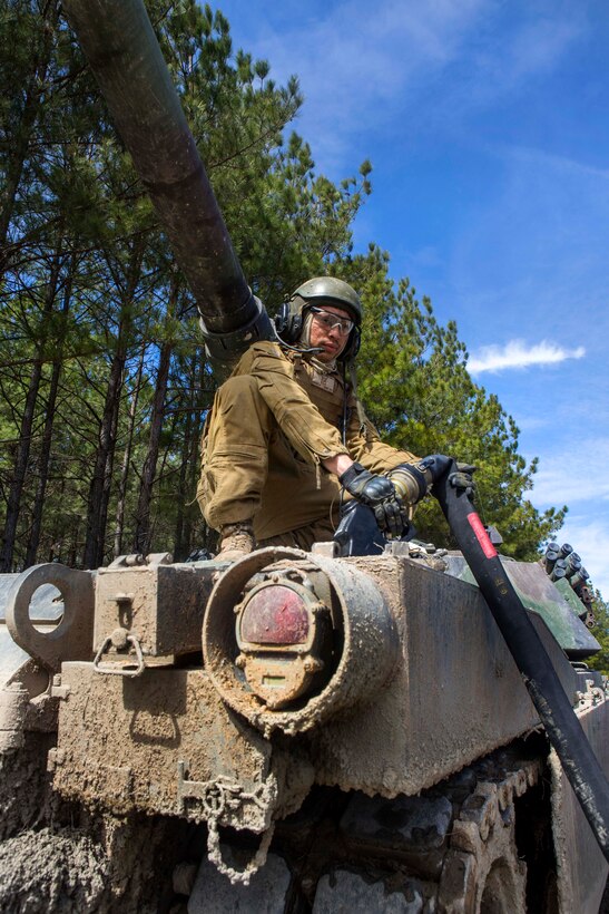 Marine Corps Cpl. Joey Denado pumps fuel into an M1A1 Abrams tank during training on Fort Pickett, Va., March 12, 2015. Denado is a tank gunner assigned to 2nd Tank Battalion, 2nd Marine Division.