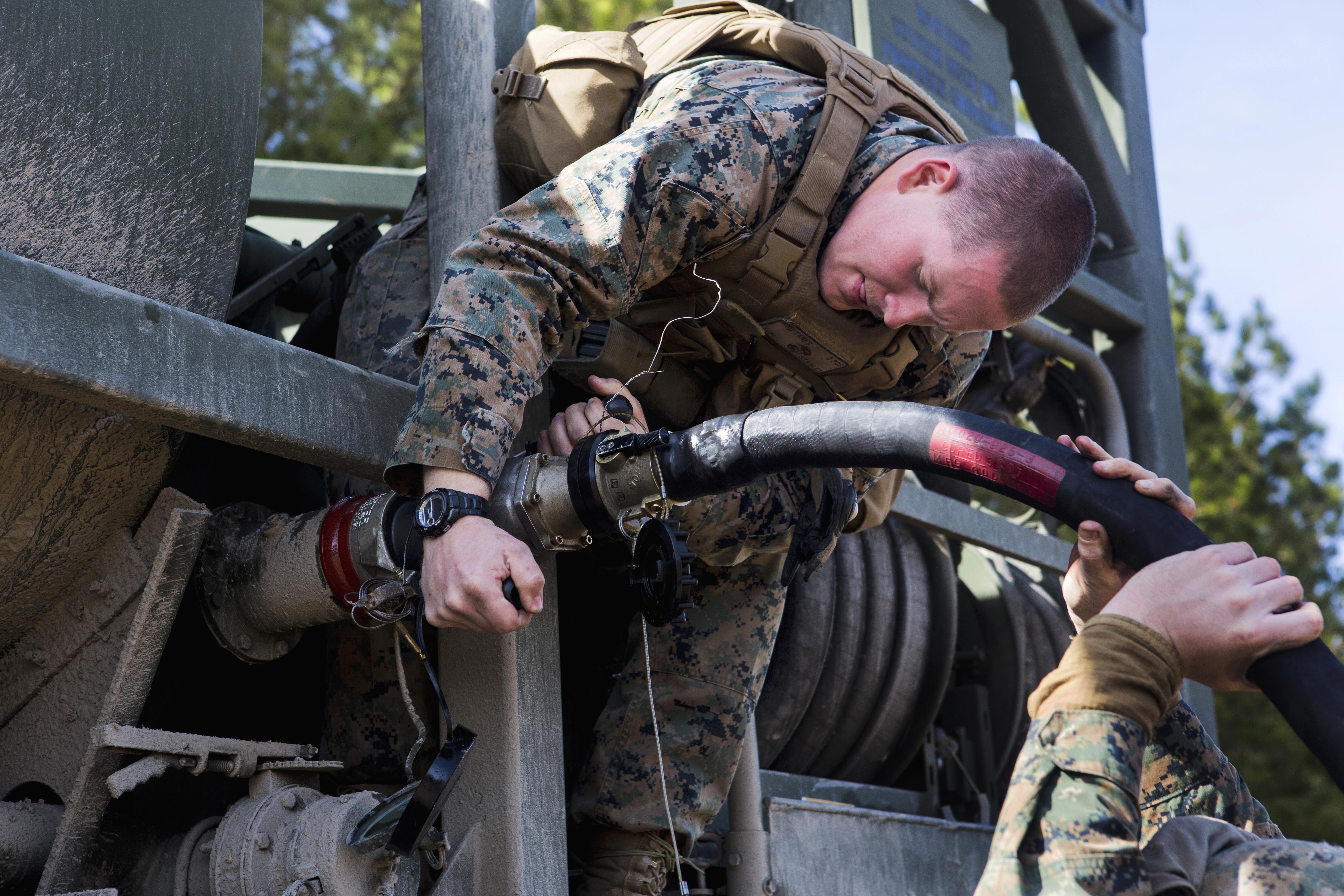 Marine Lance Cpl. Zachary Stanley Pumps Fuel Into An Auxiliary Tank On Fort Pickett Va., March