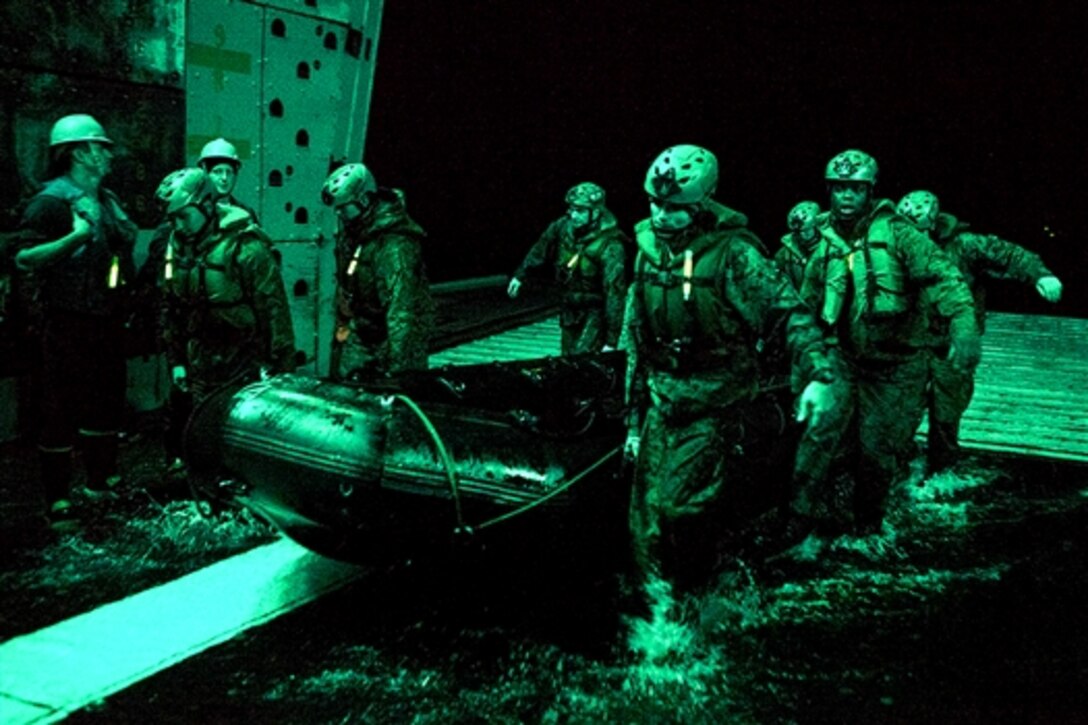 U.S. Marines conduct an exercise using a combat rubber raiding craft as part of amphibious training aboard the USS Green Bay in the Asia-Pacific region, March 11, 2015. The Marines are assigned to the 31st Marine Expeditionary Unit.