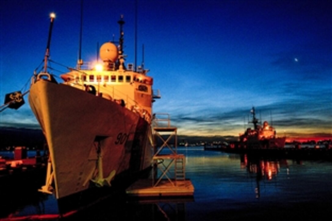The Coast Guard Cutter Bear and The Coast Guard Cutter Tampa sit moored to the pier during a sunrise on Base Portsmouth, Va., March 17, 2015.