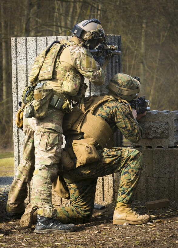 A U.S. Army Special Forces operator, left, engages targets alongside a Marine with Special-Purpose Marine Air-Ground Task Force Crisis Response-Africa during a joint training exercise in Baumholder, Germany, March 9, 2015. The Marines worked side by side with the Special Forces members to ensure the two groups are ready to support each other during potential future operations. (U.S. Marine Corps photo illustration by Sgt. Paul Peterson/Released)