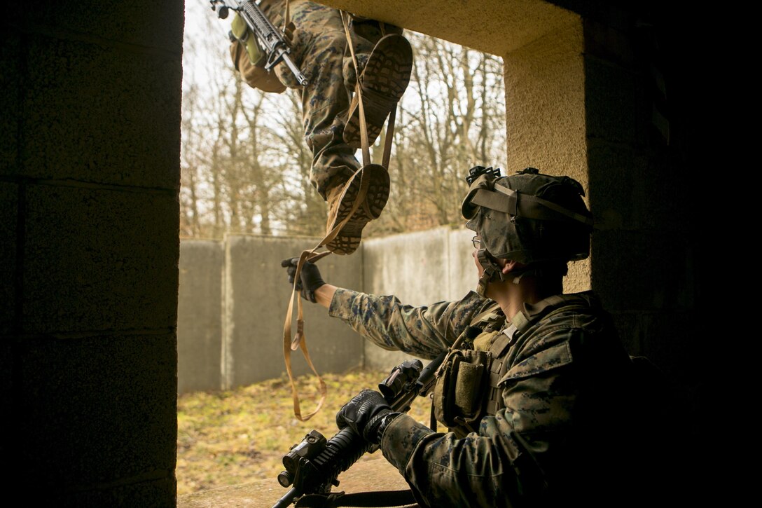 A U.S. Marine with Special-Purpose Marine Air-Ground Task Force Crisis Response-Africa uses a portable ladder to scale down the side of a building during a combat efficiency test in Baumholder, Germany, March 10, 2015. U.S. The Marines worked with U.S. Army Special Forces to develop a variety of mobility techniques designed around the unique challenges of urban environments. (U.S. Marine Corps photo by Sgt. Paul Peterson/Released)