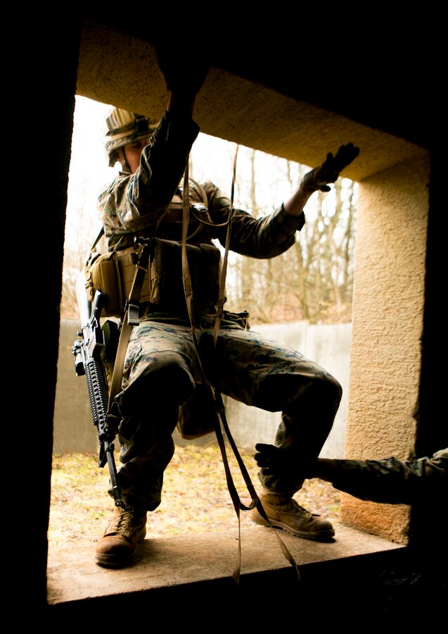 A U.S. Marine with Special-Purpose Marine Air-Ground Task Force Crisis Response-Africa climbs into a window during a combat efficiency test in Baumholder, Germany, March 10, 2015. The Marines completed a series of physically demanding obstacles prepared by U.S. Army Special Forces to test the service members’ mental flexibility and physical strength. (U.S. Marine Corps photo by Sgt. Paul Peterson/Released)