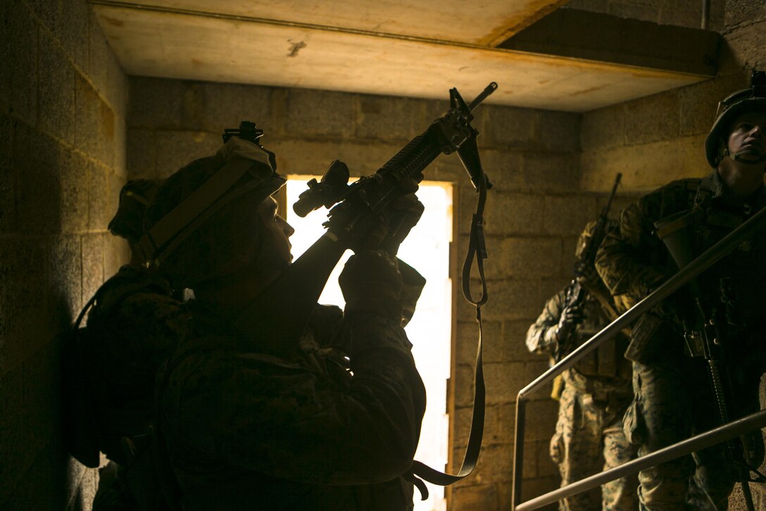 U.S. Marines with Special-Purpose Marine Air-Ground Task Force Crisis Response-Africa fight their way up a stairwell during a combat efficiency test in Baumholder, Germany, March 10, 2015. U.S. Army Special Forces personnel left markers in a series of houses, which the Marines had to clear floor by floor to retrieve. (U.S. Marine Corps photo by Sgt. Paul Peterson/Released)