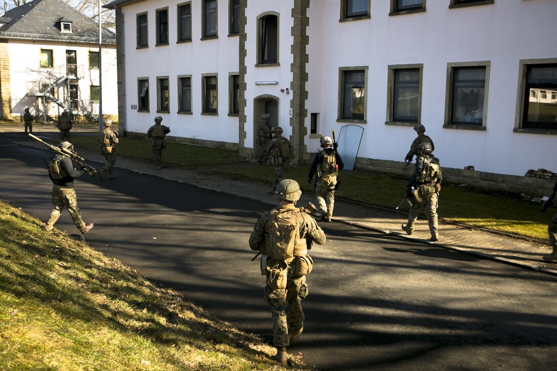 U.S. Marines with Special-Purpose Marine Air-Ground Task Force Crisis Response-Africa move into position with a U.S. Army Special Forces sniper team during a mock assault with U.S. Army Special Forces in Baumholder, Germany, March 11, 2015. The Marines quickly established a secure position, where the snipers provided over watch for a follow-on assault on a nearby building. (U.S. Marine Corps photo by Sgt. Paul Peterson/Released)