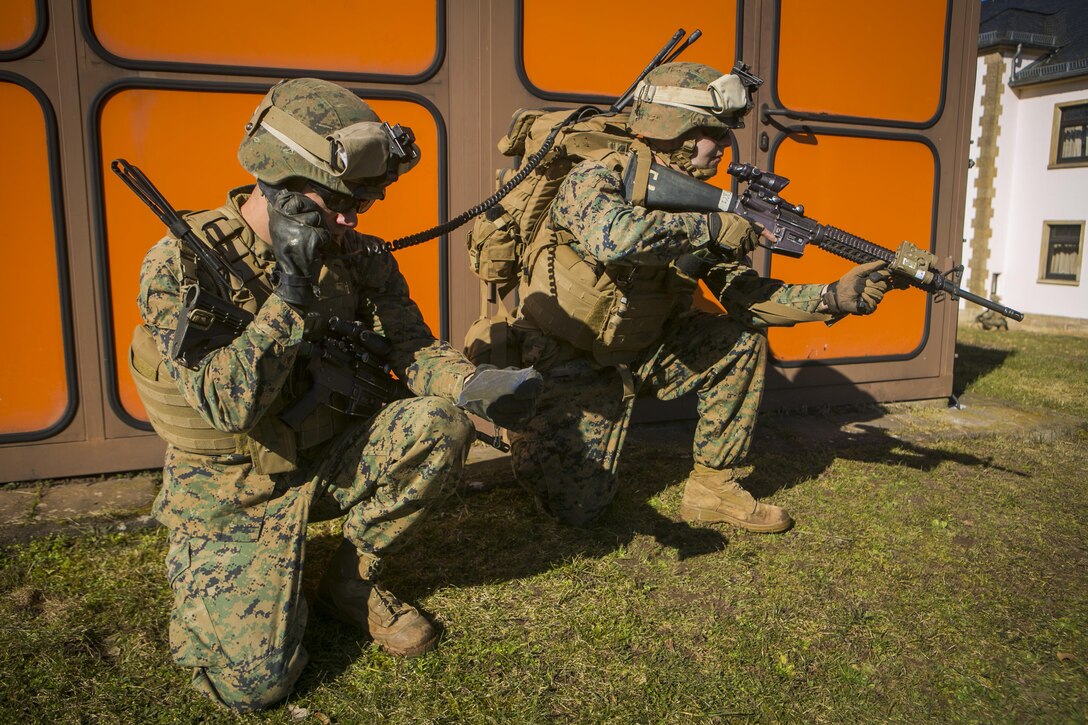 U.S. Marine 1st Lt. Matthew Medina, left, a platoon commander with Special-Purpose Marine Air-Ground Task Force Crisis Response-Africa, coordinates the movements of his Marines with U.S. Army Special Forces during a training assault in Baumholder, Germany, March 11, 2015. The Marines spent more than a week training side by side with Special Forces personnel to enhance interoperability between the two groups. (U.S. Marine Corps photo by Sgt. Paul Peterson/Released)