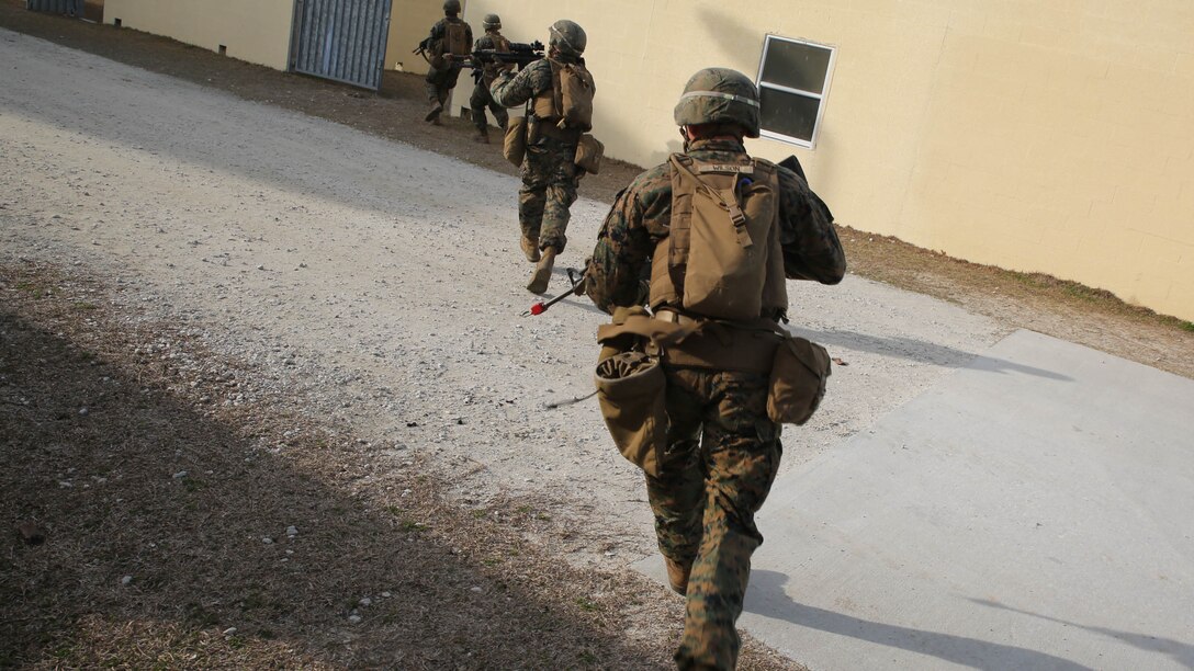 Marines with 3rd Battalion, 8th Marine Regiment, move in on a building during a military operations on urban terrain training exercise aboard Camp Lejeune, N.C., March 11, 2015. Speed and intensity during training is an important factor in preparing for urban combat scenarios in which both factors could mean survival.