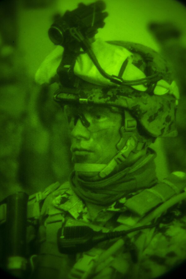 A U.S. Marine with Special-Purpose Marine Air-Ground Task Force Crisis Response-Africa waits to embark on a joint night raid during training with Army Special Forces in Baumholder, Germany, March 11, 2015. The two groups launched a coordinated assault under the cover of darkness, engaging simulated opposition forces in multiple buildings at the base. (U.S. Marine Corps photo by Sgt. Paul Peterson/Released)