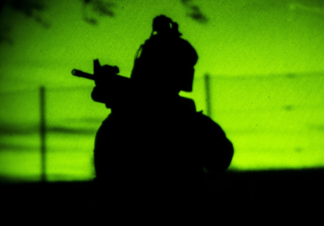 A U.S. Marine with Special-Purpose Marine Air-Ground Task Force Crisis Response-Africa provides security during a night raid while training with Army Special Forces in Baumholder, Germany, March 11, 2015. The Marines launched four squads to create a perimeter around a target building for a follow-on assault by a Special Forces team. (U.S. Marine Corps photo by Sgt. Paul Peterson/Released)