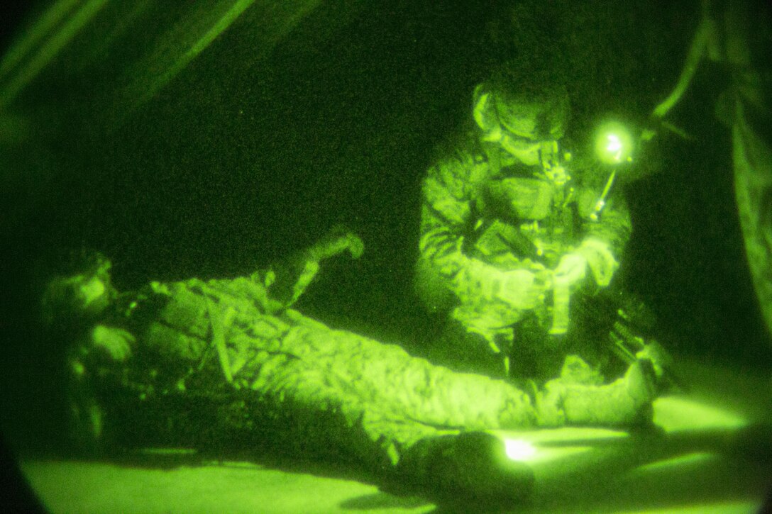 A U.S. Marine with Special-Purpose Marine Air-Ground Task Force Crisis Response-Africa provides medical aid to a simulated casualty during a training mission with Army Special Forces in Baumholder, Germany, March 11, 2015. The Marines treated and evacuated the casualty using a predetermined landing zone they secured after their initial assault. (U.S. Marine Corps photo by Sgt. Paul Peterson/Released)