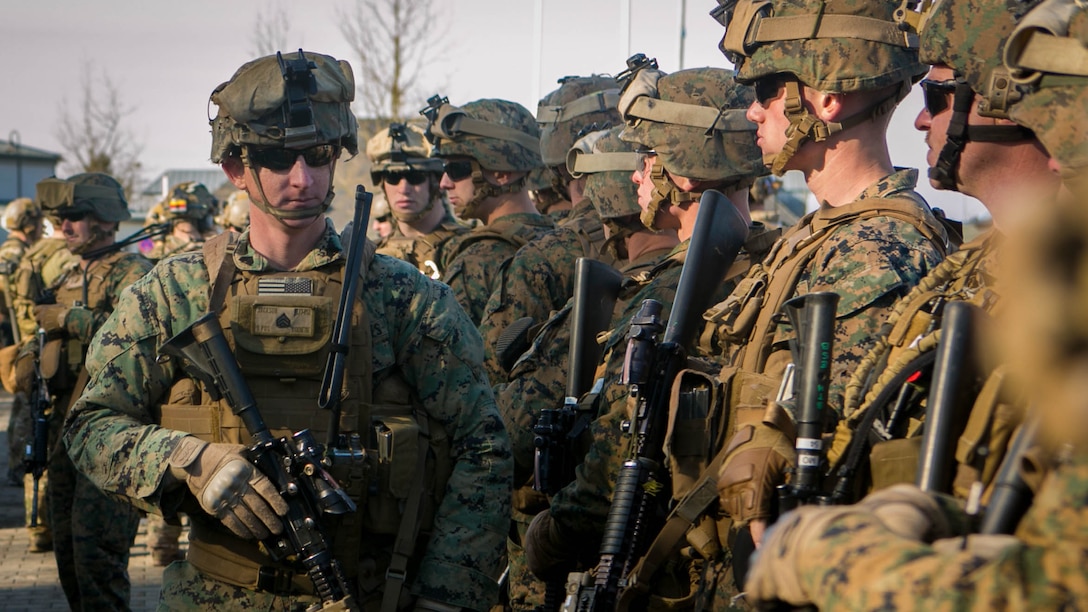 U.S. Marine Sgt. Garrett Jackson, a squad leader with Special-Purpose Marine Air-Ground Task Force Crisis Response-Africa, checks his team before setting out on a mock assault with U.S. Army Special Forces in Baumholder, Germany, March 11, 2015. Jackson led his squad through more than a week of training with Special Forces personnel to prepare the two groups to conduct future operations together.