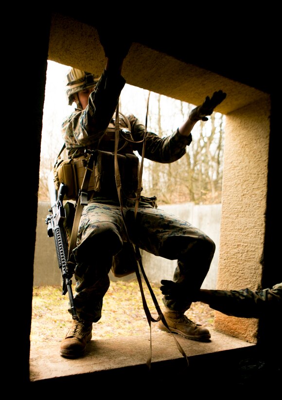 A U.S. Marine with Special-Purpose Marine Air-Ground Task Force Crisis Response-Africa climbs into a window during a combat efficiency test in Baumholder, Germany, March 10, 2015. The Marines completed a series of physically demanding obstacles prepared by U.S. Army Special Forces to test the service members’ mental flexibility and physical strength. (U.S. Marine Corps photo by Sgt. Paul Peterson/Released)