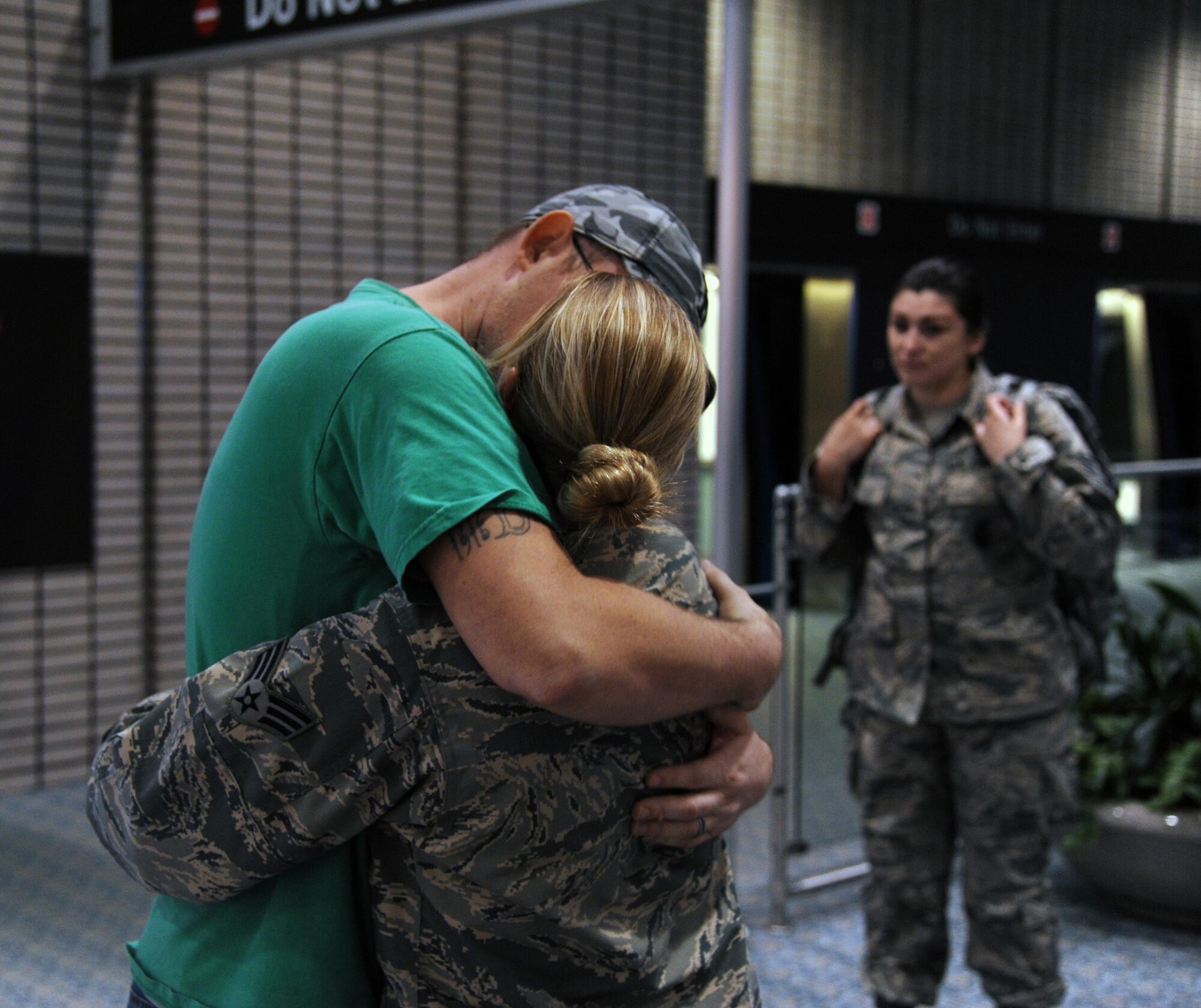 Daniel Rumfelt, hugs his wife Senior Airman Cammie Rumfelt, goodbye on March 15, during an early morning send-off. Senior Airman Rumfelt and her fellow 927th Security Forces Squadron members are deploying to perform base security and anti-terrorism duties at an undisclosed location in Southwest Asia. (U.S. Air Force photo/Tech Sgt. Peter Dean) 